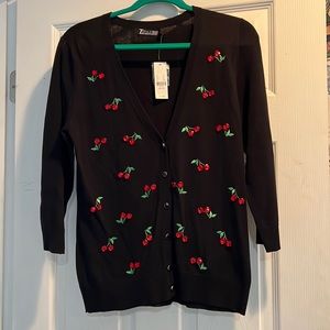 Black button up cardigan with cherry decoration.